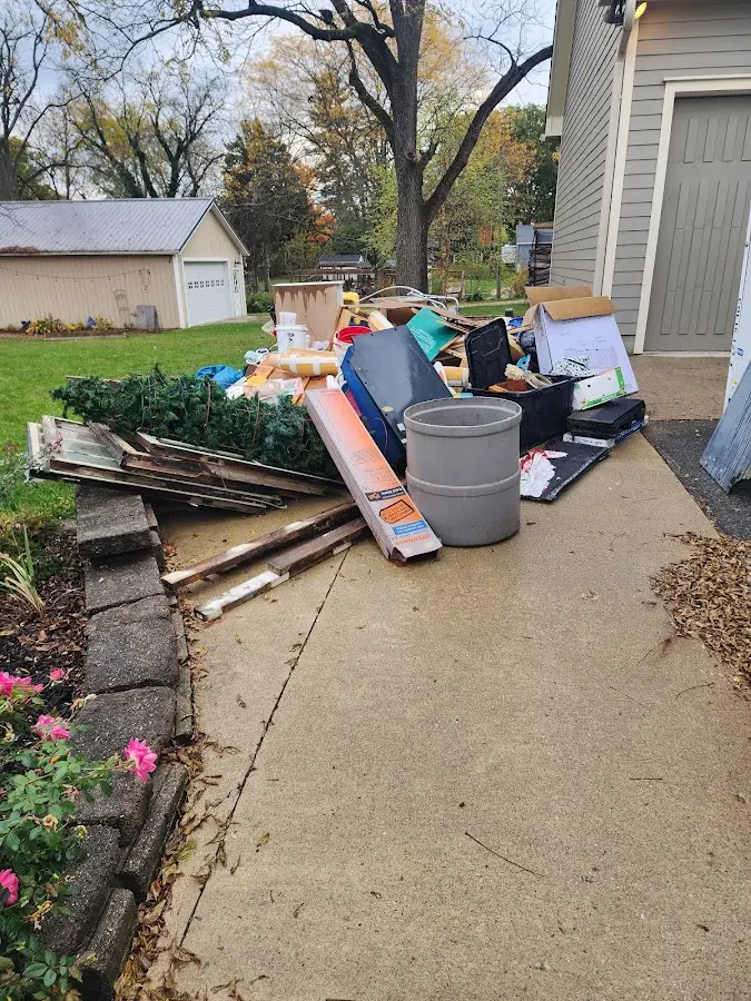 Dumpster being loaded with debris for Demolition Dumpster Rental in Grand Forks